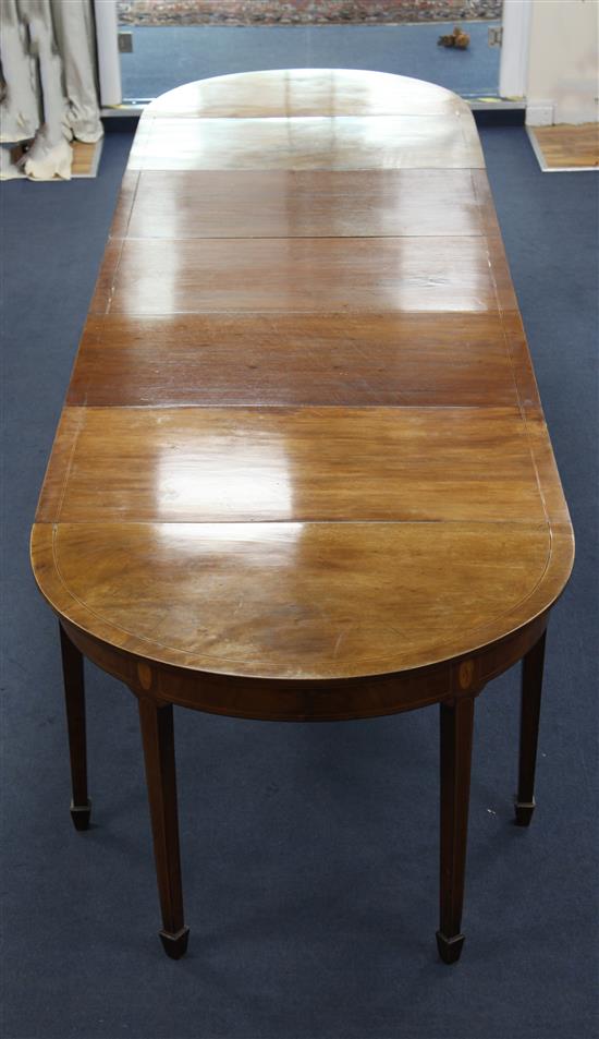 A George III inlaid mahogany extending dining table, extends to 12ft 10in. W.3ft 8in. H.2ft 6in.